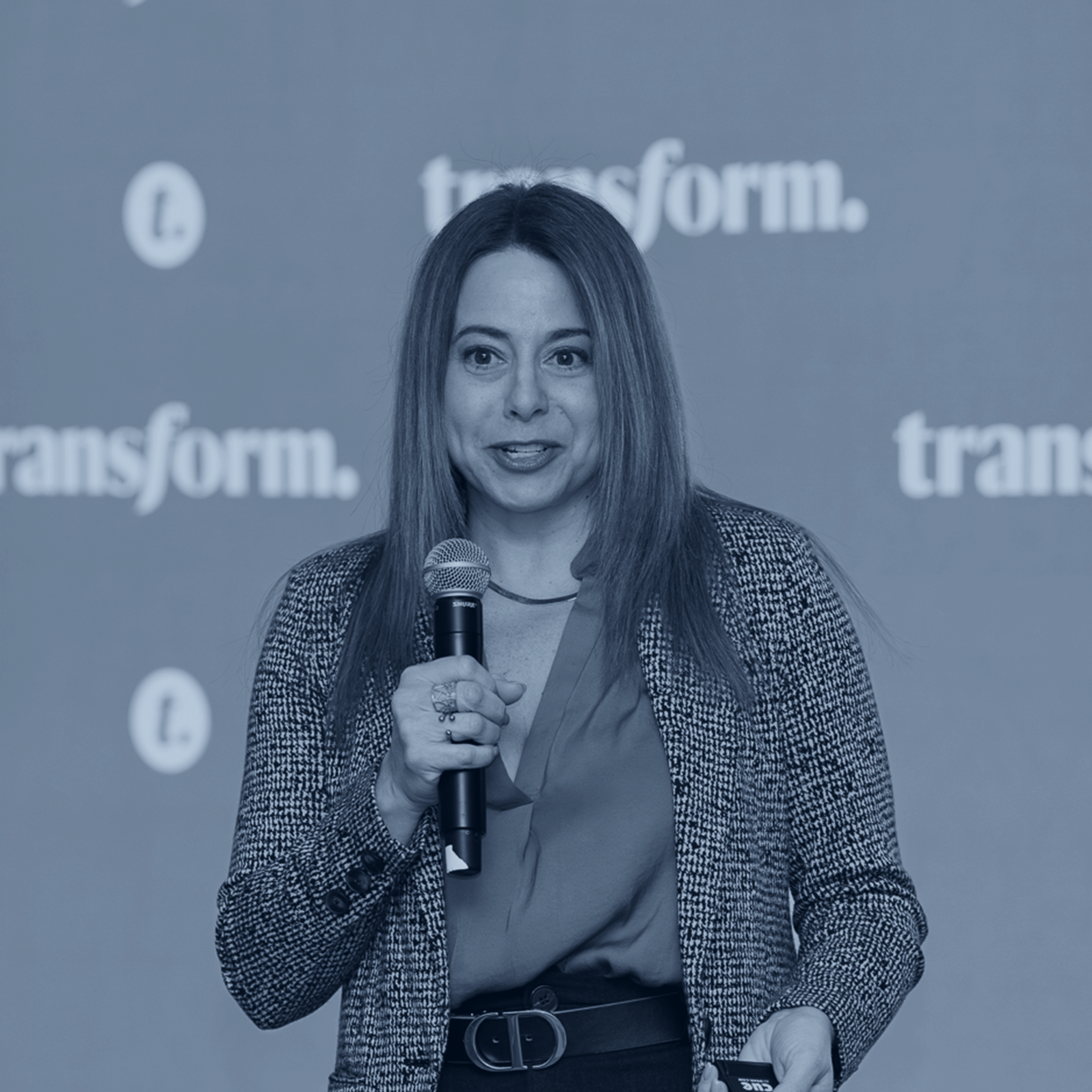 Ann Melinger on a stage at Transform conference giving a presentation